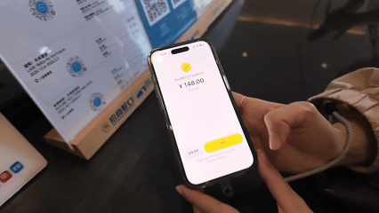 Shin Seon-yi from South Korea make payments with Korean e-wallet Kakao Pay at Sea World Culture and Arts Center..gif